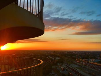 High angle view of illuminated city against sky during sunset