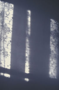 Close-up of text on window against sky