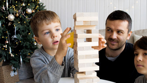 Portrait of father and boy at christmas tree