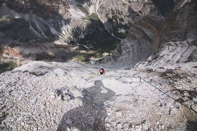 Man standing on cliff against mountain