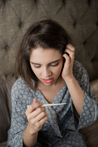 Close-up of young woman using mobile phone outdoors