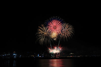 Low angle view of firework display at night