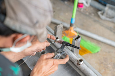 Midsection of man working at workshop