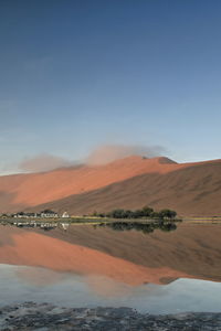 1127 sumu jaran lake and badain jaran desert temple-sand megadunes reflected on mirror water. china.