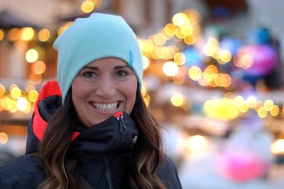 Portrait of smiling young woman in park during winter