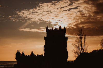 Low angle view of silhouette building against sky during sunset