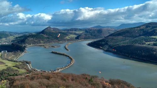 High angle view of lake and mountains against sky