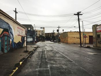 Empty road along buildings