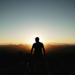 Silhouette man standing against clear sky