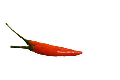 Close-up of red chili peppers against white background