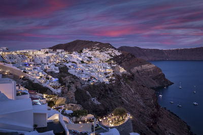 High angle view of townscape by sea against sky