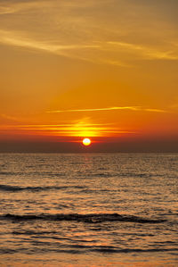 Scenic view of sea against romantic sky at sunset