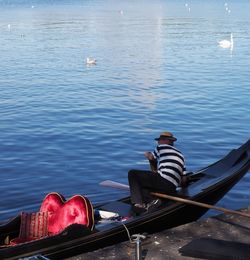 Rear view of man sitting in sea