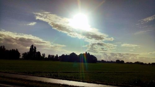 Scenic view of field against rainbow in sky