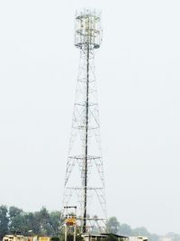 Low angle view of electricity pylon against clear sky