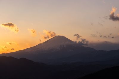 Scenic view of silhouette mountains against sky during sunset