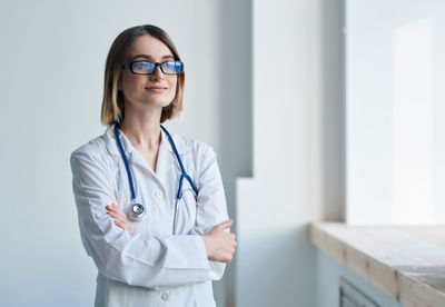 Doctor looking away while standing at hospital