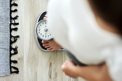 Midsection of woman standing against wall