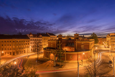 Illuminated buildings against sky at night