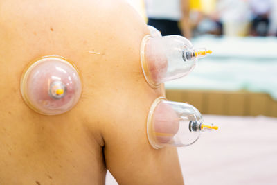 Midsection of woman holding bottle