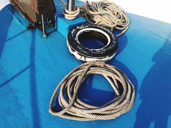 High angle view of ropes tied up on metal