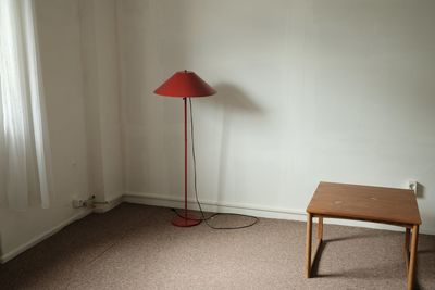 Empty chair on table against wall at home