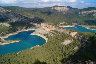 High angle view of lake and mountains against sky