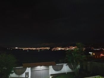 Low angle view of illuminated city against sky at night