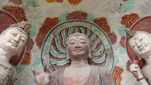 Close-up of statue against temple building