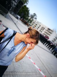 Smiling woman standing on street in city