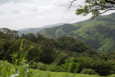 Scenic view of mountains against cloudy sky