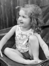 Close-up of cheerful girl sitting in hammock