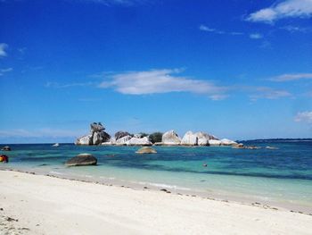 Scenic view of beach against blue sky