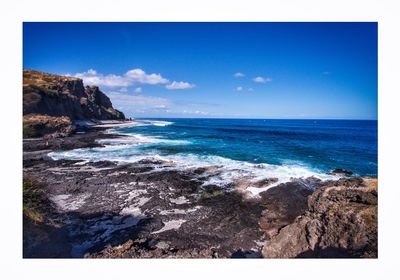 Scenic view of sea against blue sky