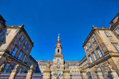 Low angle view of buildings against blue sky