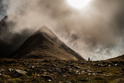 View of volcanic mountain against cloudy sky