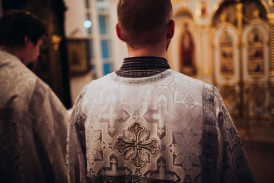 Rear view of man standing at temple