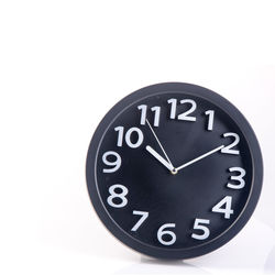 Close-up of clock on white background