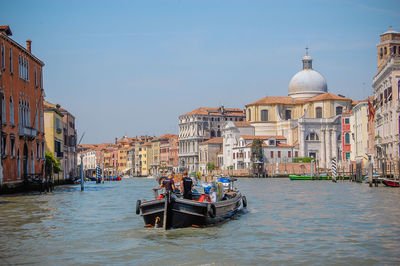 Boats in canal with buildings in background