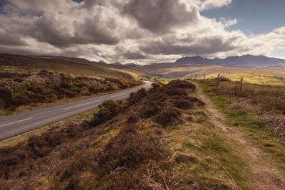 Empty road along countryside landscape