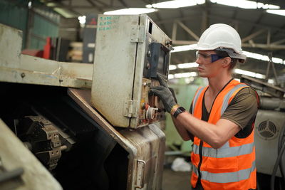 Portrait of male worker standing in the heavy industry manufacturing factory.