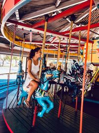 Woman sitting in amusement park ride