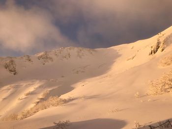 Scenic view of sand dunes against sky