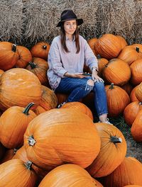 Portrait of smiling boy with pumpkins in field