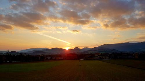 Scenic view of field against sky during sunset