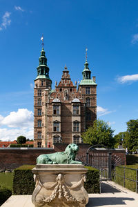 Fountain in city against sky