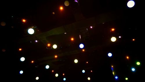 Illuminated lights against sky at night