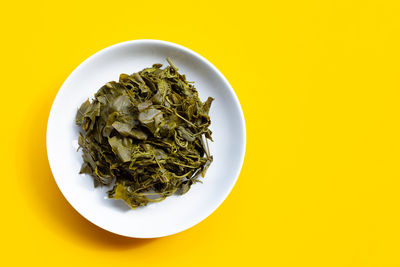 Directly above shot of food on table against yellow background