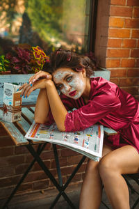 Portrait of woman sitting on chair