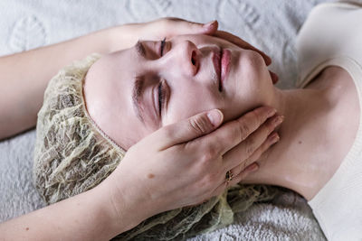 Cropped hands massaging woman